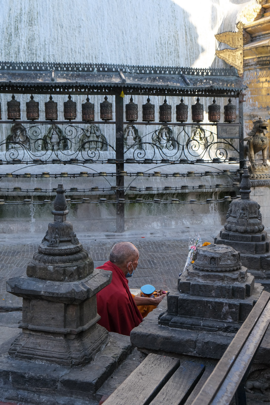 Monk sitting by stupa=