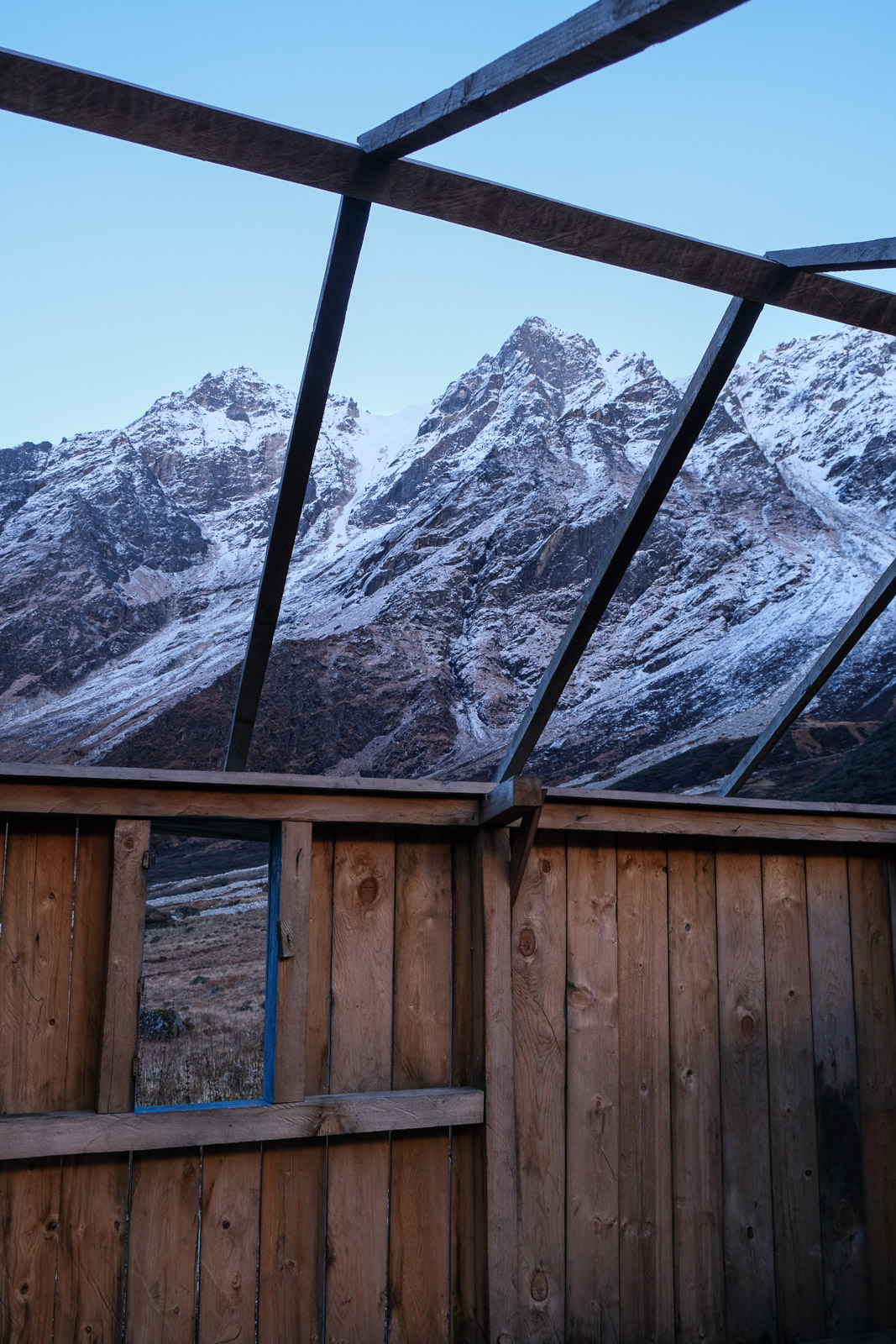 Mountain through roofless hut=