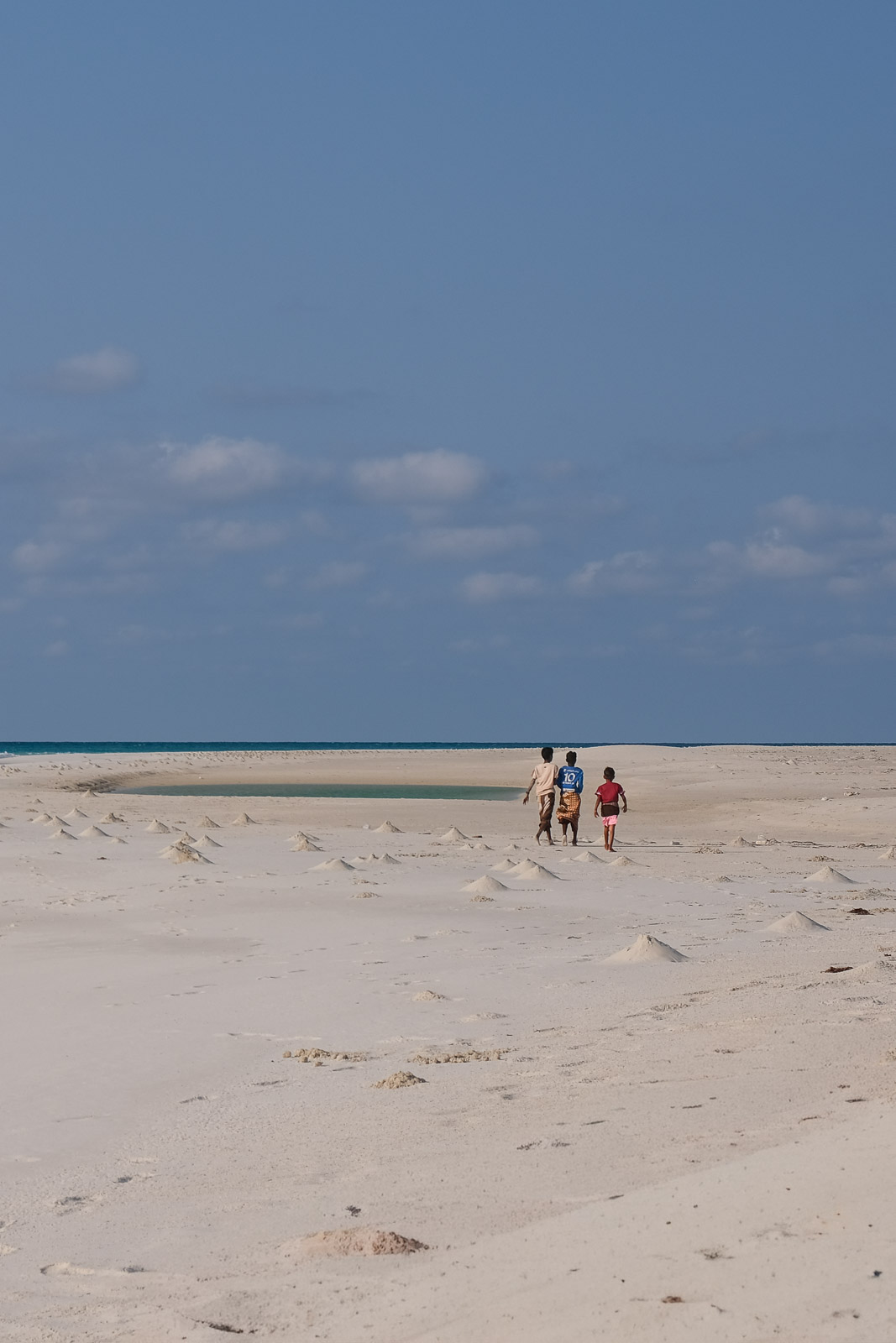Kids walking on beach=